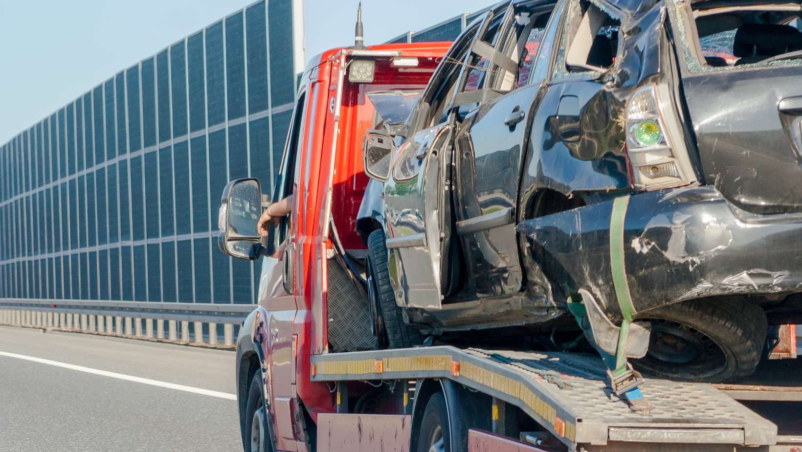 A broken auto being transported