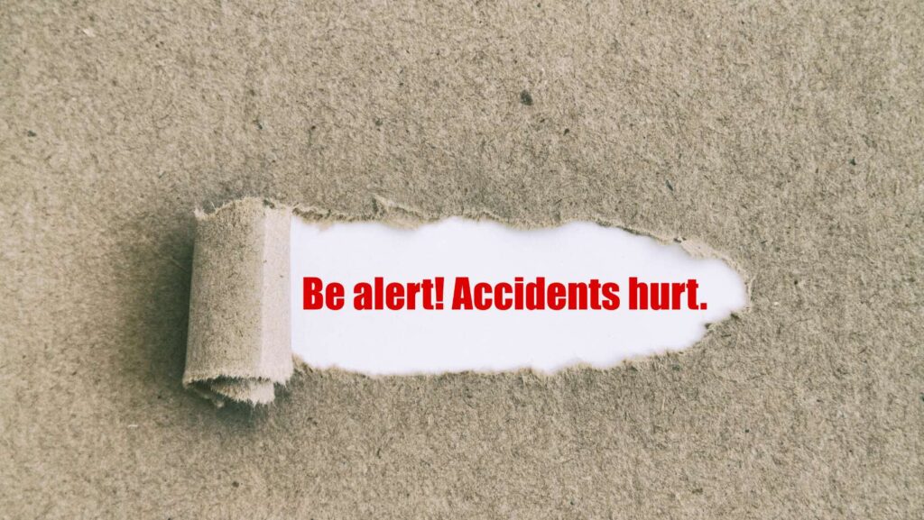 Be alert. Accidents hurt. written under a turn paper