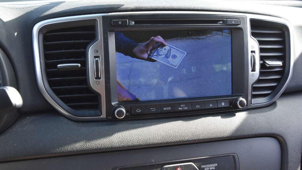 Money in a reverse camera of a vehicle. Insurance Scam Concept