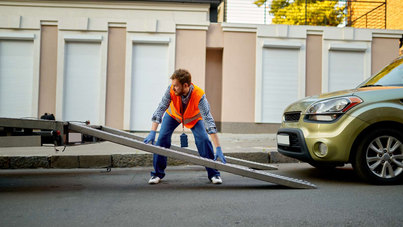 Worker Preparing Truck Platform for Car