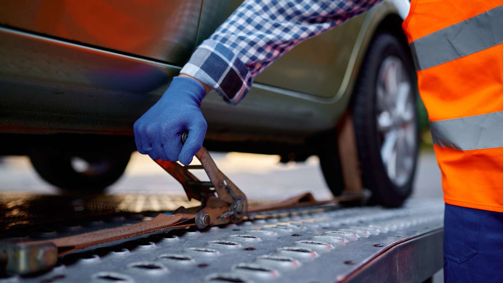 closeup securing safety of a car about to be transported