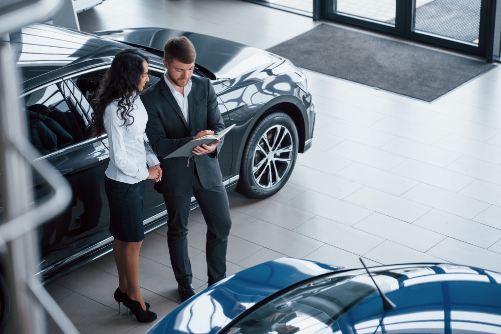 female customer and modern stylish bearded businessman in the automobile saloon