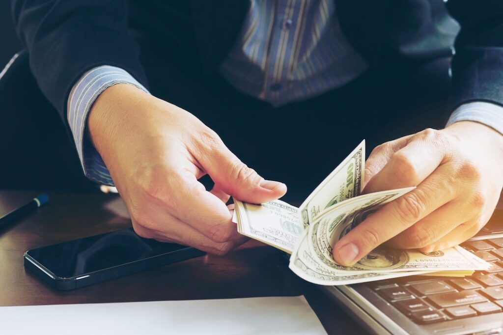 Business man counting dollar banknote