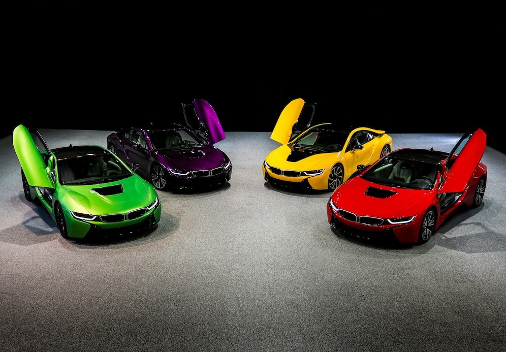 green, yellow, red, purple, violet sedan sport cars standing on dark space